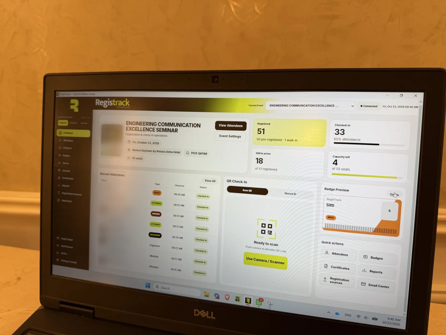 RegisTrack dashboard on a laptop showing live registered and checked-in counts at a seminar